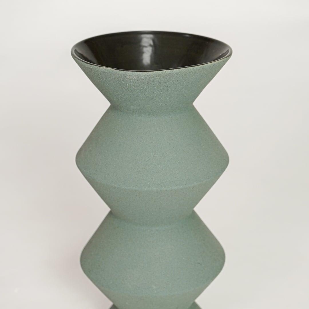 Green ceramic geometric decorative vase with smooth textured finish perfect for elegant dried floral display and modern interior decor.