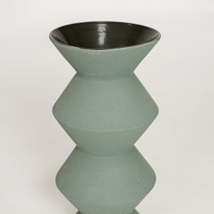 Green ceramic geometric decorative vase with smooth textured finish perfect for elegant dried floral display and modern interior decor.