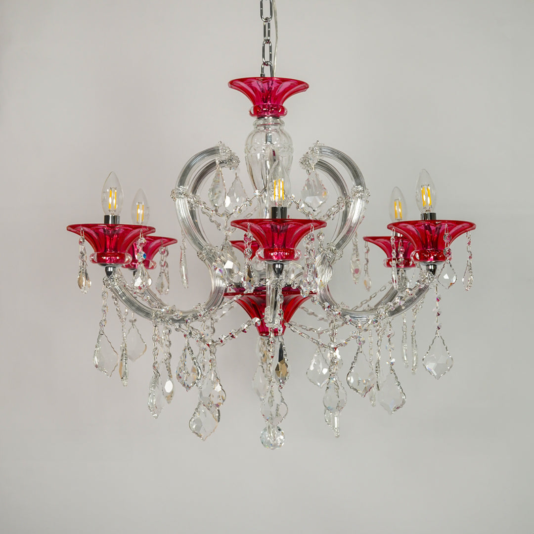 A five-light crystal chandelier featuring vibrant red glass candle-style cups and clear glass teardrop pendants, suspended from a silver chain against a plain light gray background.