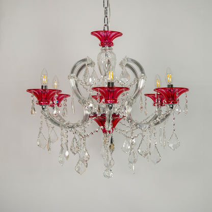 A five-light crystal chandelier featuring vibrant red glass candle-style cups and clear glass teardrop pendants, suspended from a silver chain against a plain light gray background.