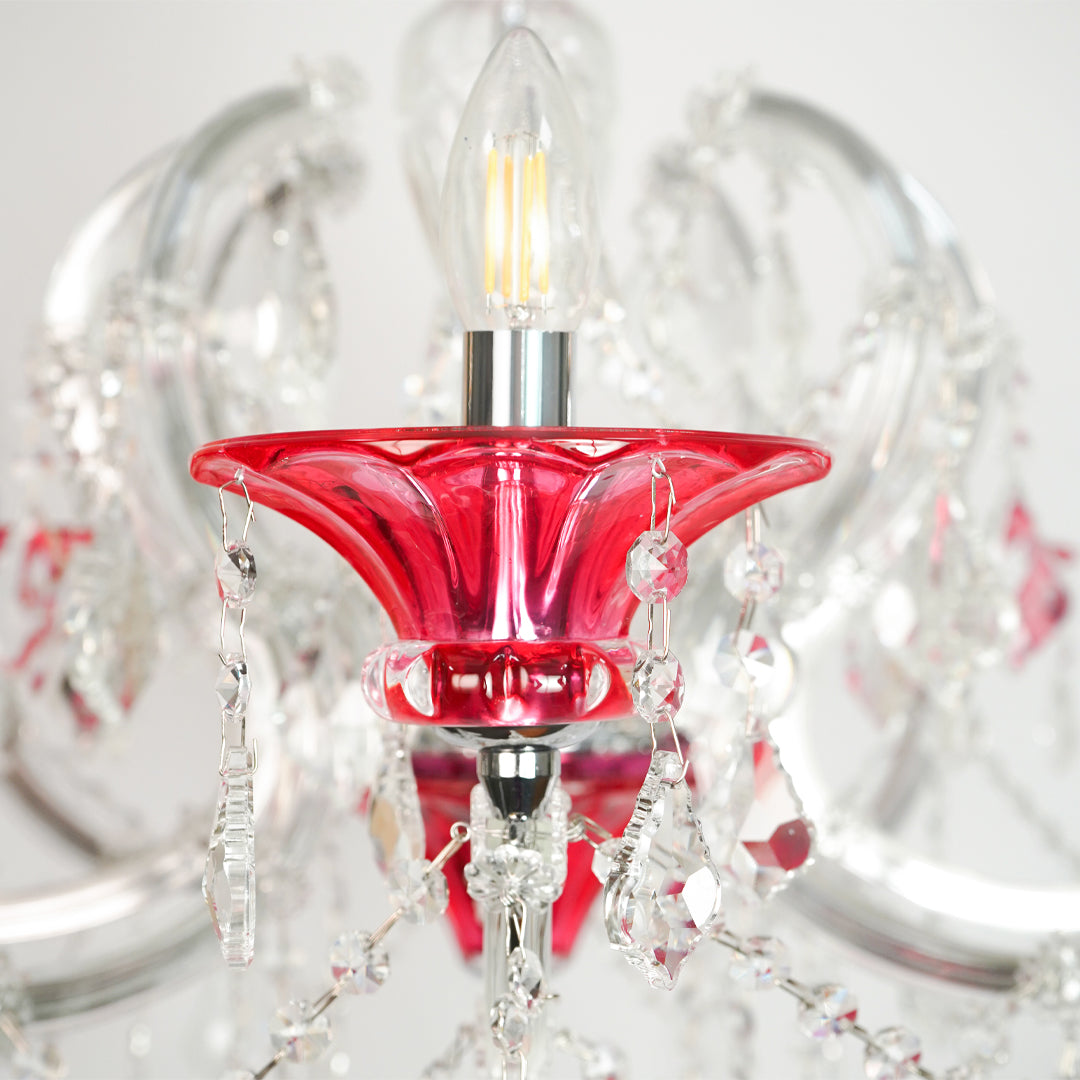 Closeup image of red and clear glass baccarat style chandelier for modern dining room decor styling with elegant detailings.