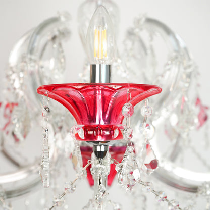 Closeup image of red and clear glass baccarat style chandelier for modern dining room decor styling with elegant detailings.