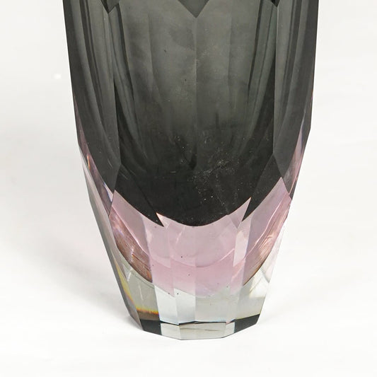 Detailed closeup of grey and pink glass decorative vase highlighting faceted texture and refined glossy surface.