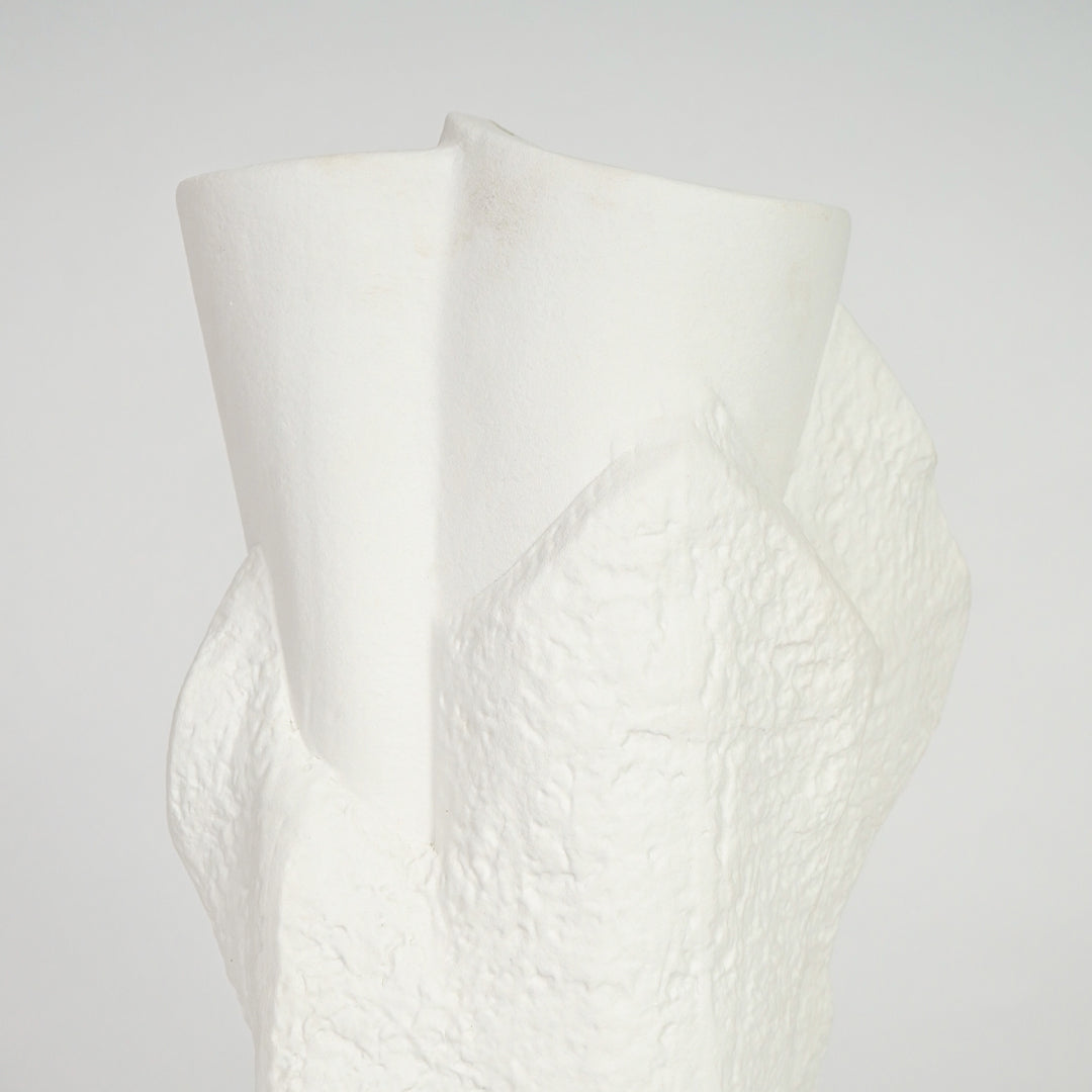 Closeup image of white ceramic abstract vase for modern console table decor styling with textured artistic finish.