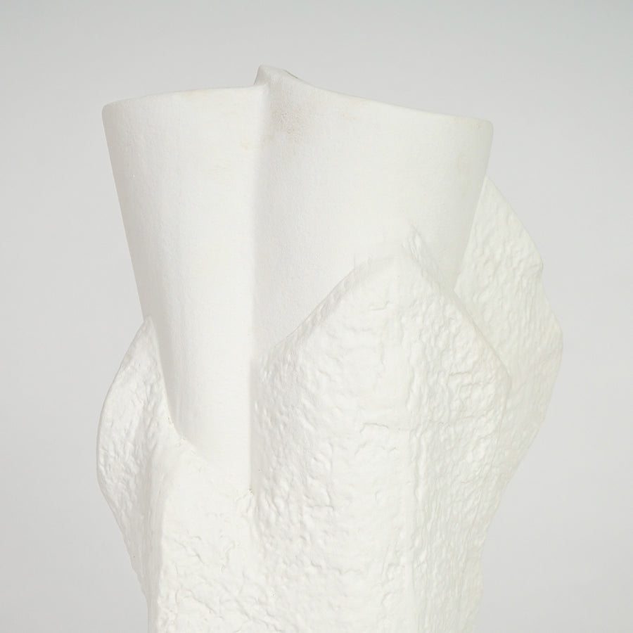 Closeup image of white ceramic abstract vase for modern console table decor styling with textured artistic finish.