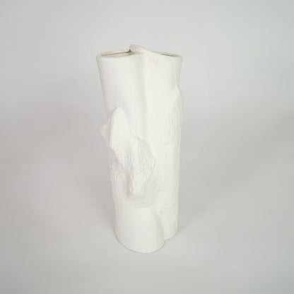White textured ceramic vase for stylish shelf placement and contemporary living room decor styling statement piece.