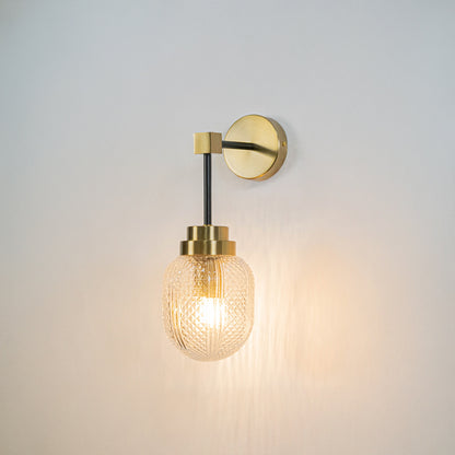 Minimal wall light with gold mount and exposed filament bulb on neutral wall background modern lighting perfect for bedroom living room decor.
