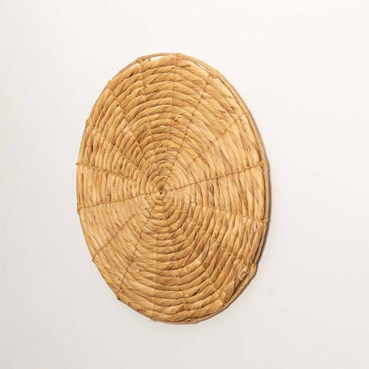 Side view of handcrafted solid natural wicker seagrass wall basket with woven spiral pattern for bohemian wall decor.