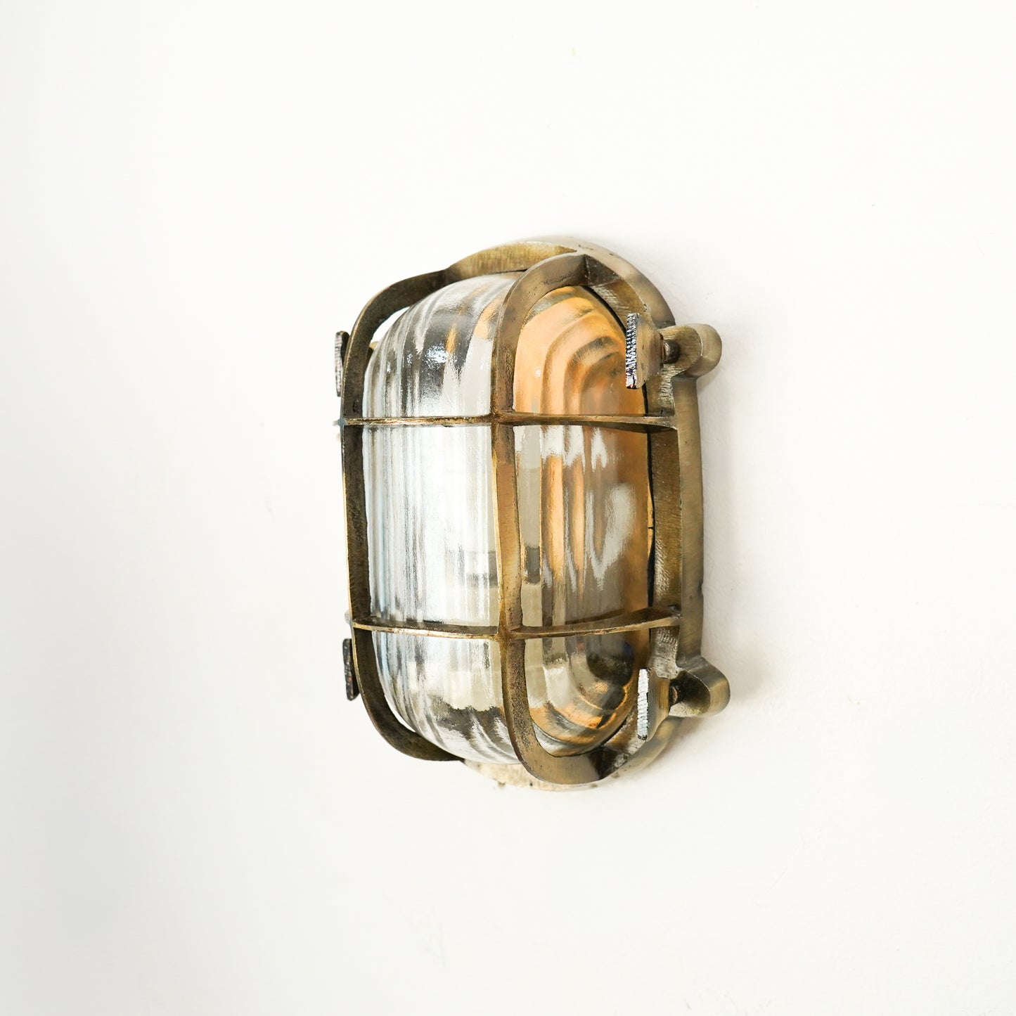 Closeup image of nautical steampunk bulkhead sconce light fixture for elegant home exterior decor and modern wall lighting.