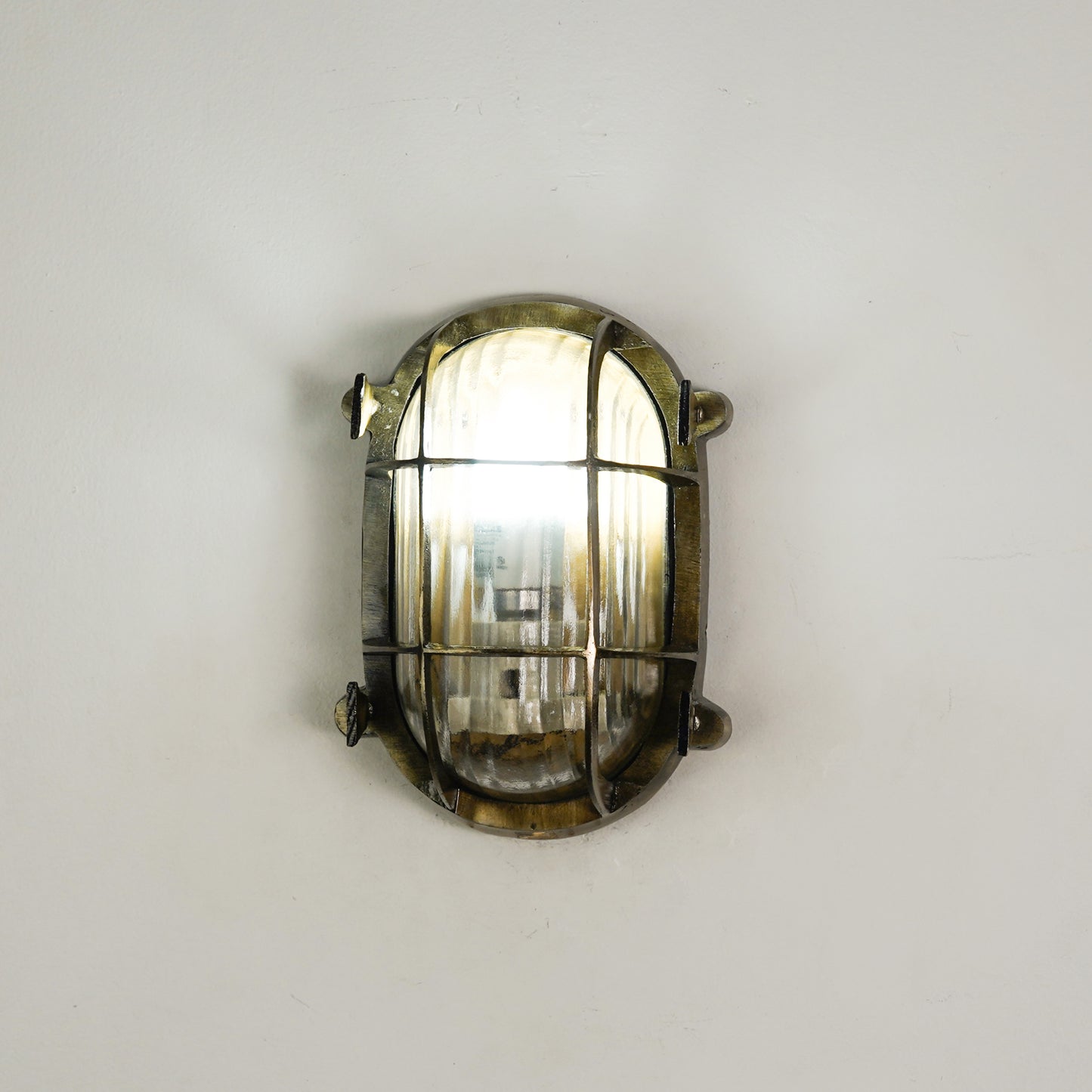 White background image of nautical steampunk bulkhead sconce light fixture for elegant home exterior decor and home lighting.