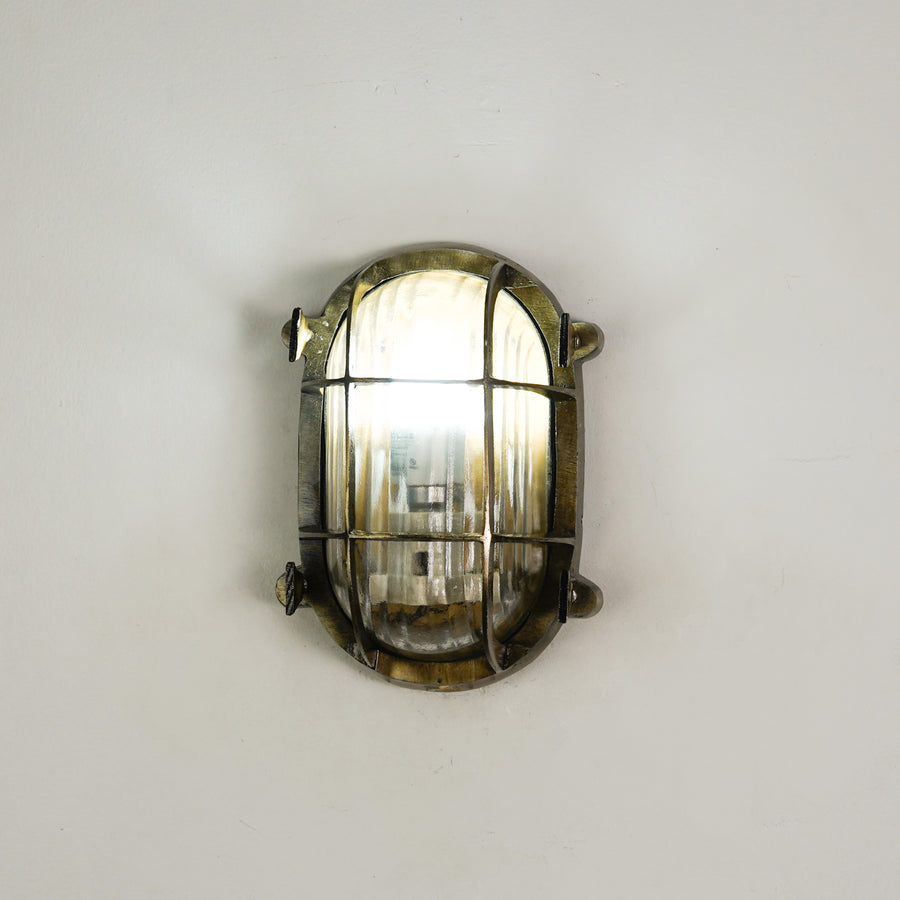 White background image of nautical steampunk bulkhead sconce light fixture for elegant home exterior decor and home lighting.
