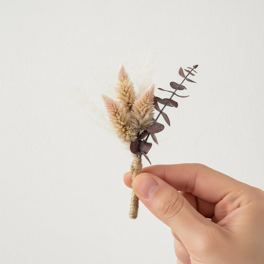 Small dried flower bouquet with beige pink and brown preserved florals held in hand perfect for rustic decor and craft use.