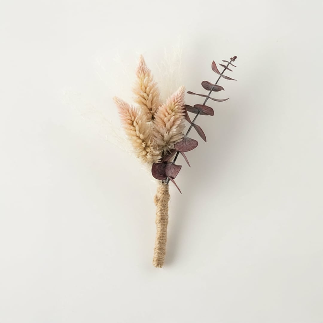 Dried floral stem bouquet with soft beige pampas and muted eucalyptus leaves on white background highlighting natural texture minimal decor charm.
