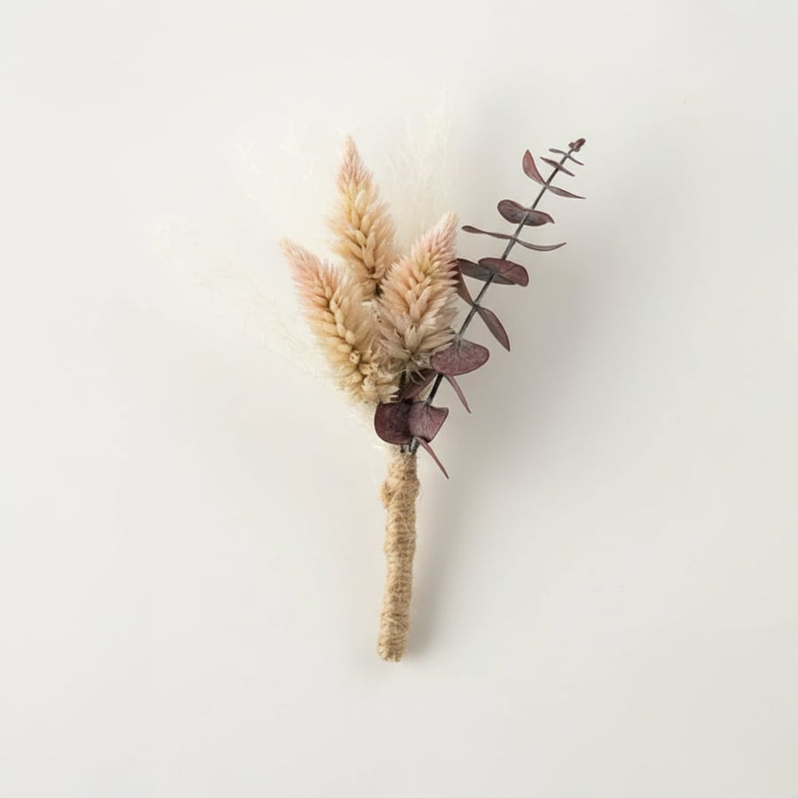 Dried floral stem bouquet with soft beige pampas and muted eucalyptus leaves on white background highlighting natural texture minimal decor charm.