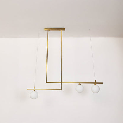 Gold pendant light with frosted glass globes and linear frame in off mode displayed on white background for decor view.