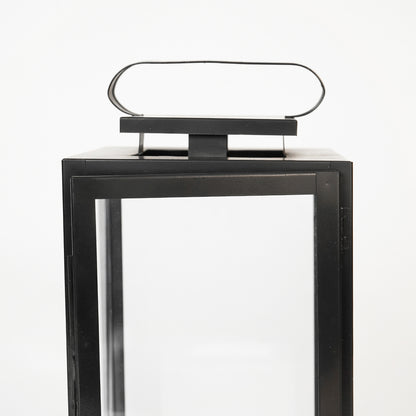 Closeup image of large metal tower lantern for modern tabletop decor styling with durable sleek metallic finish detailing.