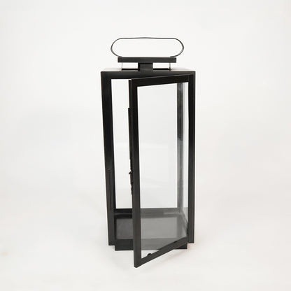White background image of large metal tower lantern for modern indoor decor styling with clear glass side panels display.