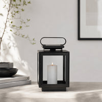 Lifestyle image of small metal tower lantern for rustic patio decor styling and modern outdoor home garden lighting.