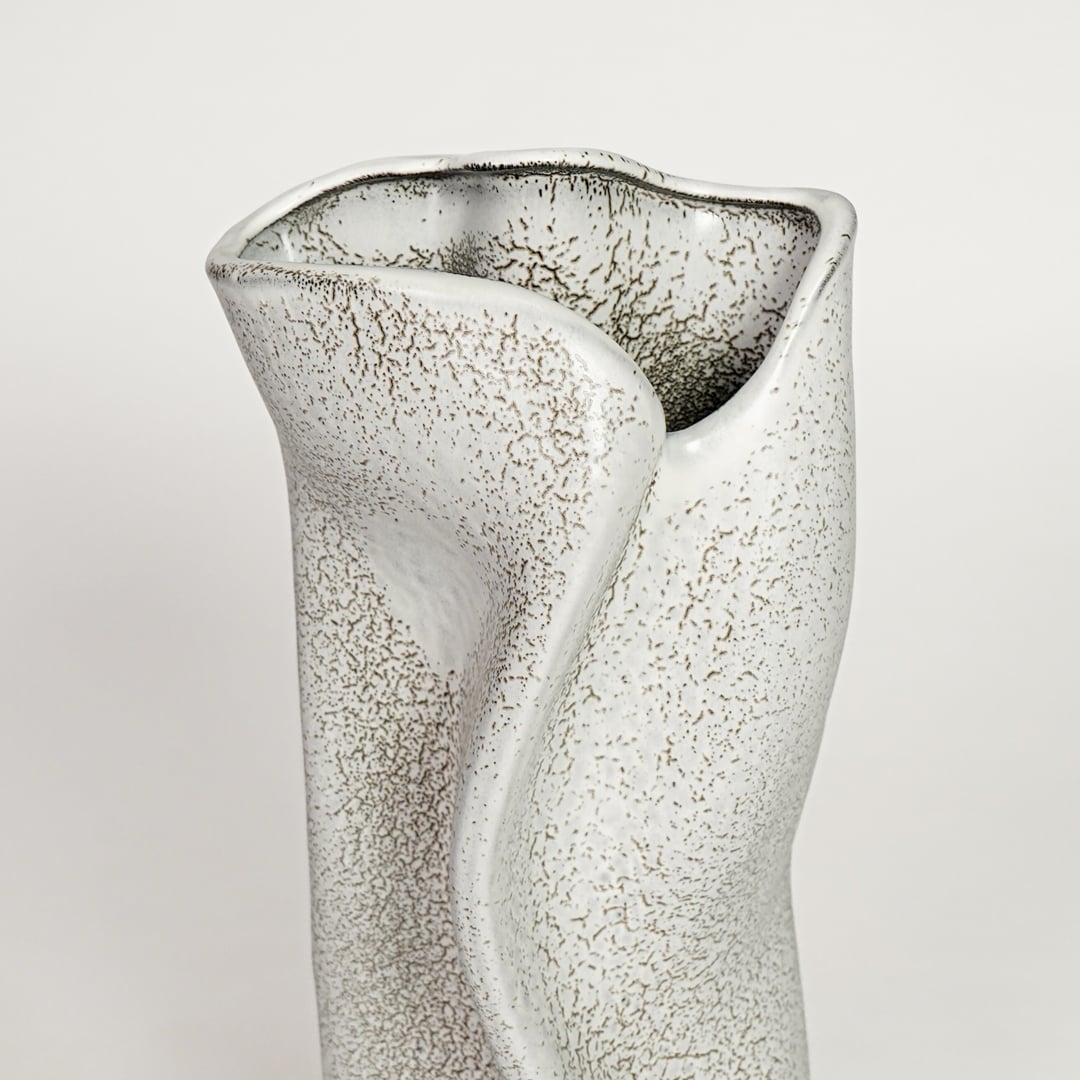 White ceramic decorative vase with textured artistic surface and sculpted wave design perfect for elegant dried floral display.