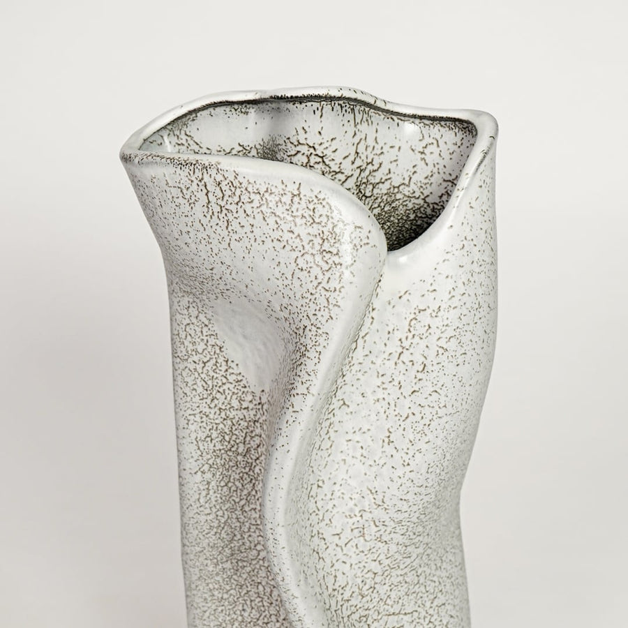 White ceramic decorative vase with textured artistic surface and sculpted wave design perfect for elegant dried floral display.