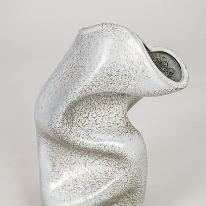 Closeup grey ceramic textured abstract designer vase surface detail modern decorative flower vase for table shelf home decor styling.