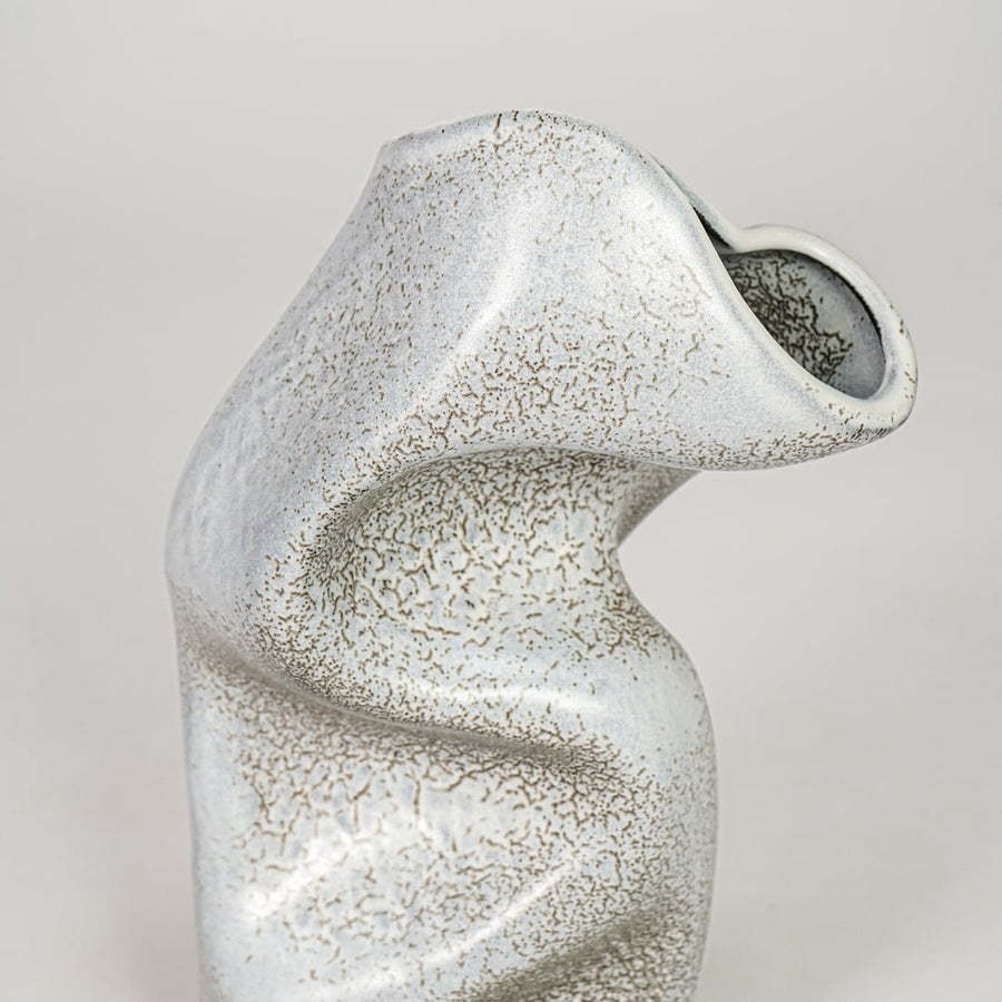 Closeup grey ceramic textured abstract designer vase surface detail modern decorative flower vase for table shelf home decor styling.