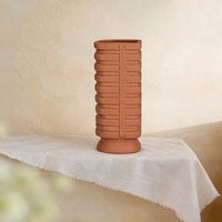 Terracotta ceramic flower vase with textured ribbed finish for elegant tabletop and shelf decor styling ideas.