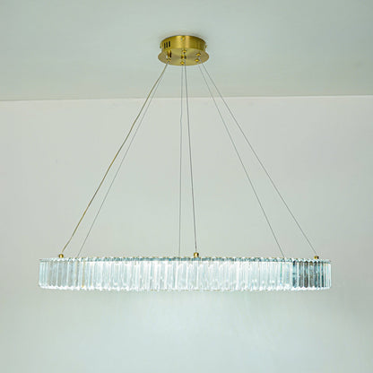 Elegant long crystal chandelier with transparent glass elements and gold finish suspended against clean ceiling background for premium modern decor.
