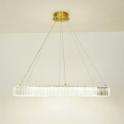 Contemporary linear crystal pendant light with gold metal frame suspended against clean white ceiling background ideal for modern dining or living space lighting.