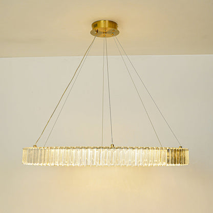 Modern crystal chandelier with gold ceiling mount installed in luxury hallway with wooden console and arched window background for elegant interior lighting.