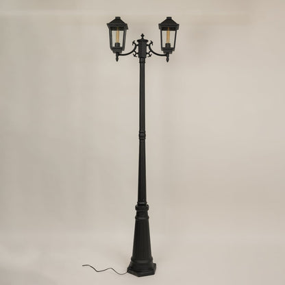 Black metal dual lantern outdoor lamp post light off highlighting classic frame and ribbed glass ideal for enhancing pathway driveway and garden Decor.