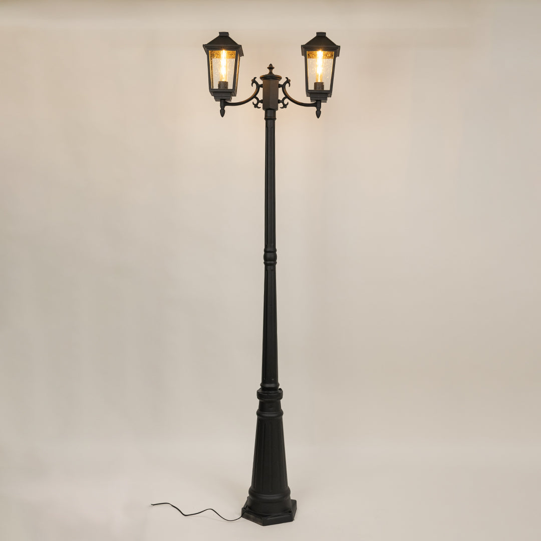 Decorative black outdoor street lamp with warm glowing lanterns for luxury exterior decor use.