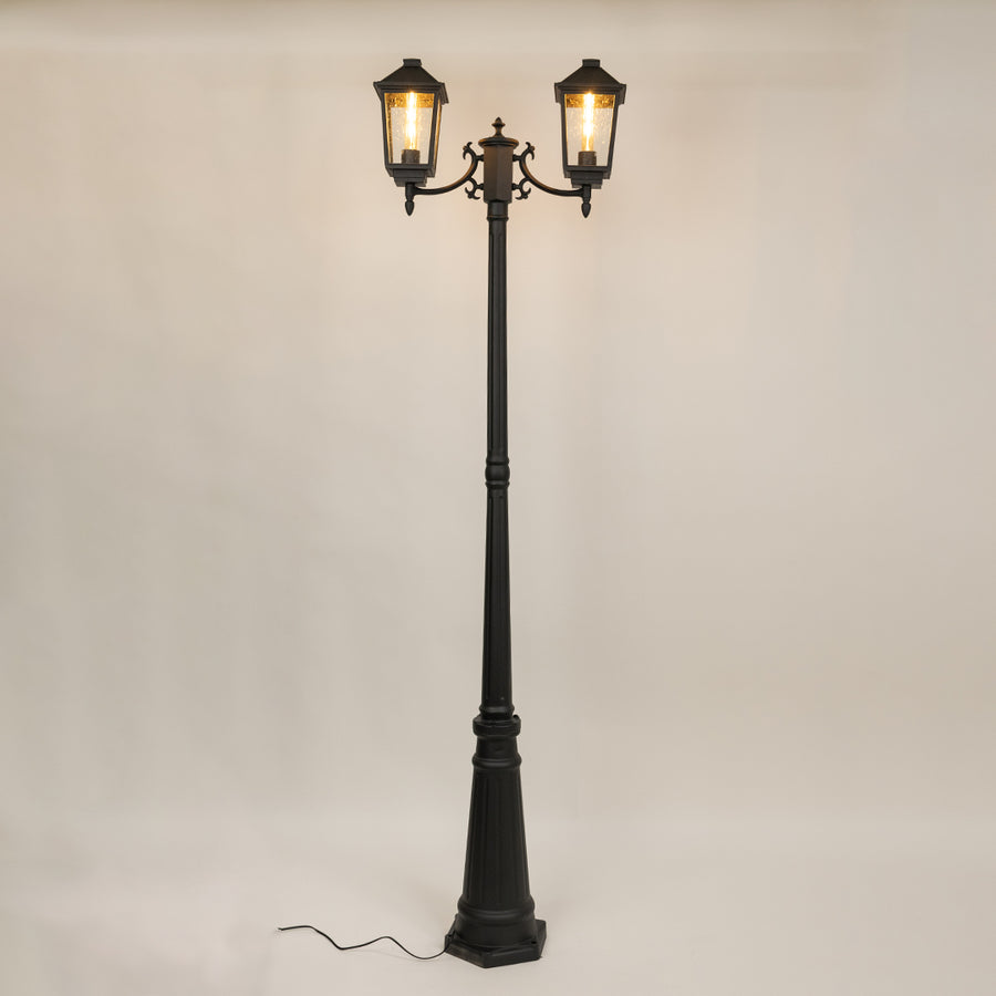 Decorative black outdoor street lamp with warm glowing lanterns for luxury exterior decor use.