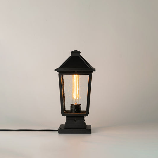 Black outdoor gate light with ribbed glass panels for stylish modern exterior decor use.