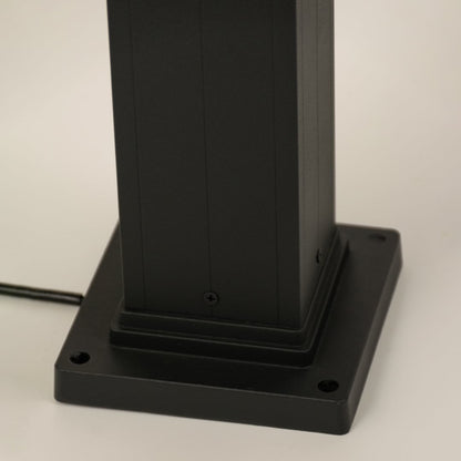 A focused closeup highlighting the top section of the outdoor post light showing the cap design glass texture and structural detailing.
