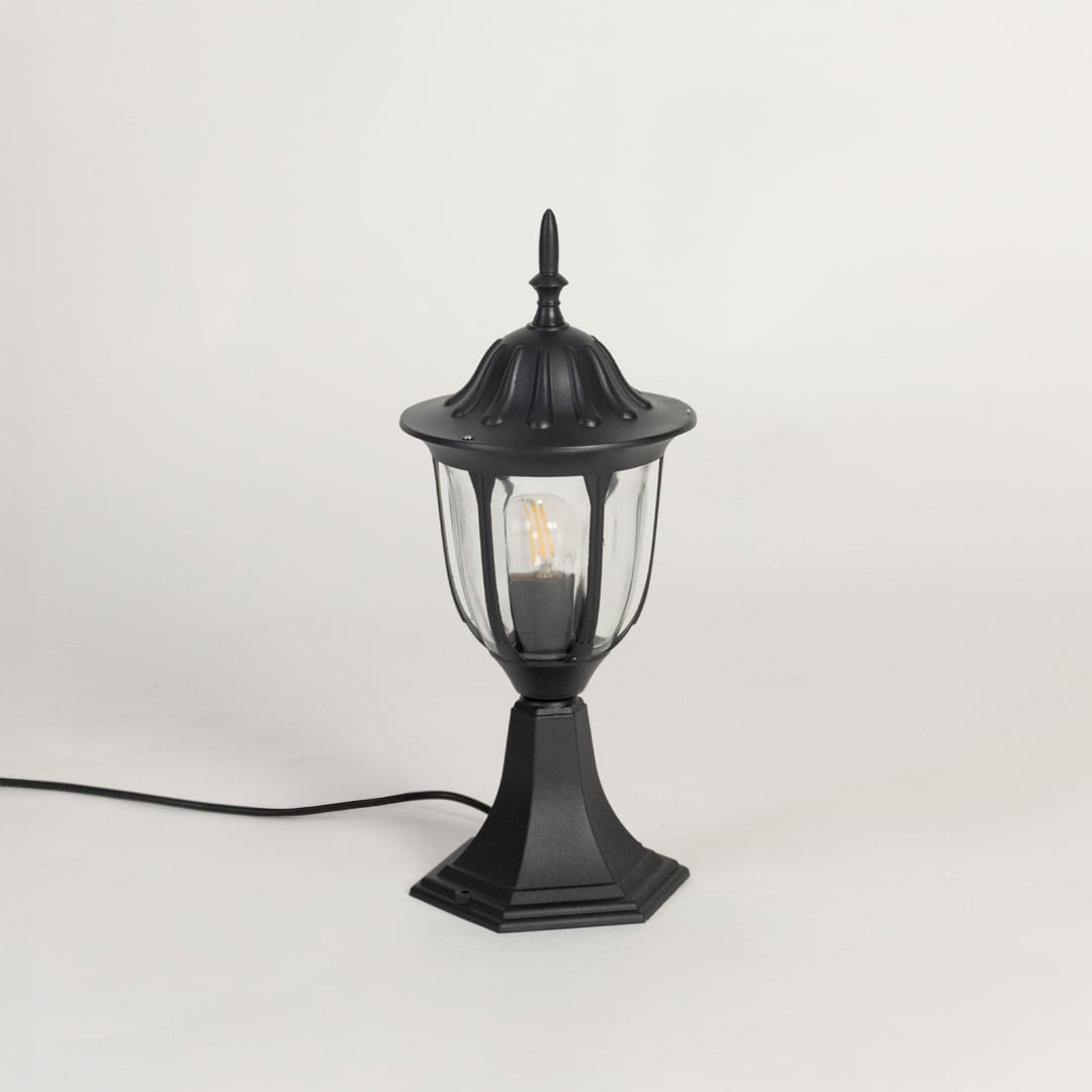Classic black pillar lamp with clear glass panels shown with light off on white background for garden and gate lighting.
