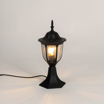 Vintage black outdoor gate light with warm glowing bulb for elegant exterior decor styling use.