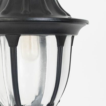 Modern black metal hanging lantern light with curved clear glass panels for stylish outdoor lighting decor.