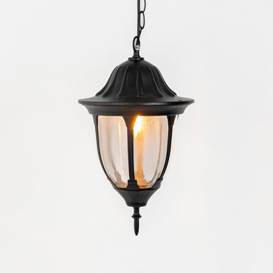 Elegant black metal hanging lantern light with warm glow for modern balcony and patio decor.
