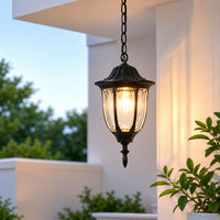 Decorative black metal outdoor hanging lantern for porch entrance balcony and exterior spaces with warm ambient lighting.