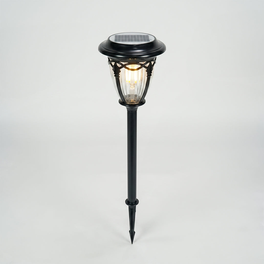 Black metal solar garden pathway light for lawn walkway landscape lighting on white background image.