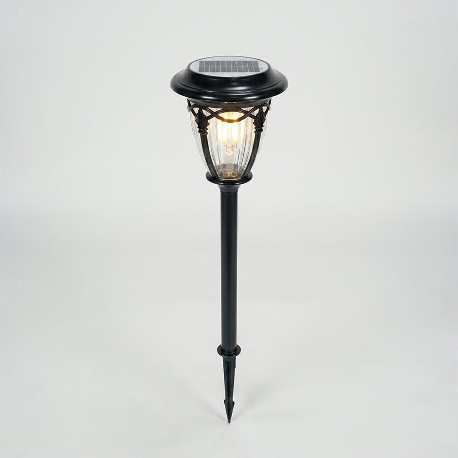Black metal solar garden pathway light for lawn walkway landscape lighting on white background image.