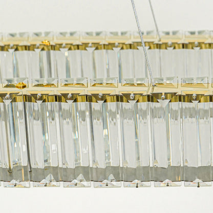 Close up crystal bar pendant light with gold metal detailing and hanging glass elements against white background perfect for elegant interior decor.