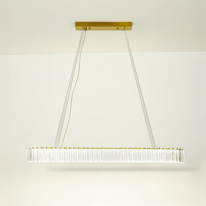 Elegant long bar pendant light with gold metal finish suspended on cables against neutral wall background ideal for luxury interior decor lighting.
