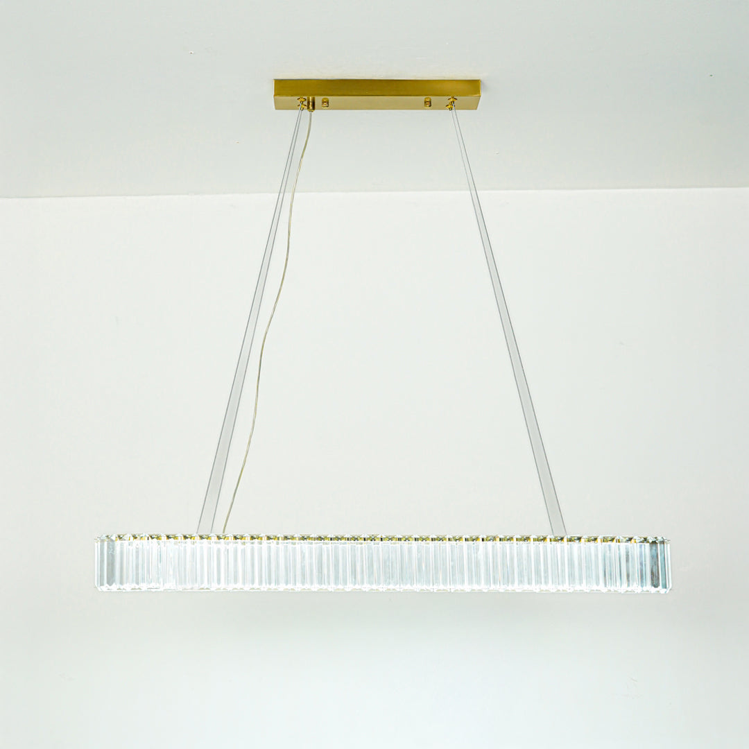 Contemporary white linear chandelier with sleek metal frame suspended by thin cables against minimal ceiling background for modern home lighting.
