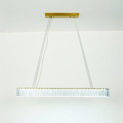 Contemporary white linear chandelier with sleek metal frame suspended by thin cables against minimal ceiling background for modern home lighting.