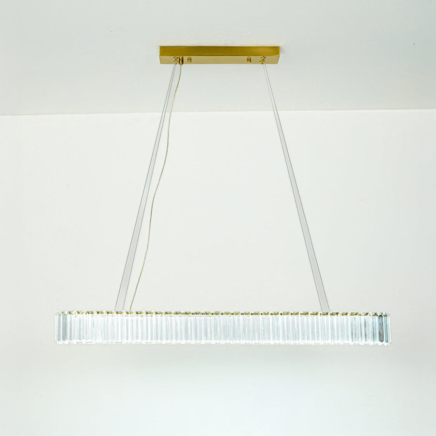 Contemporary white linear chandelier with sleek metal frame suspended by thin cables against minimal ceiling background for modern home lighting.