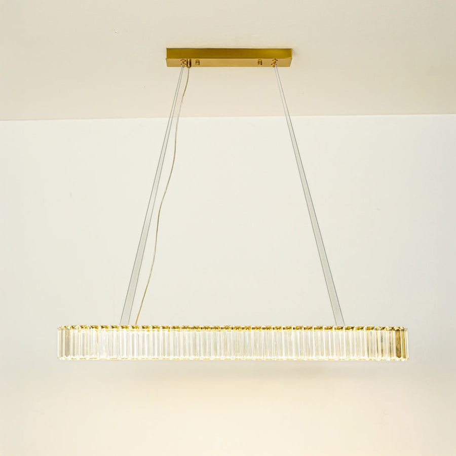 Minimal gold linear chandelier with slim design hanging against clean white ceiling background perfect for modern dining or kitchen lighting.