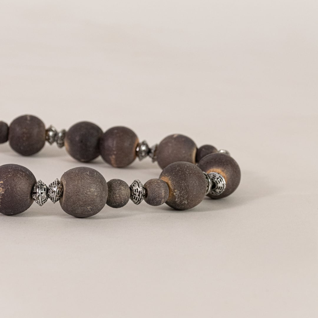 Closeup of decorative wooden bead garland showing round natural beads rustic finish and handcrafted home decor detailing.
