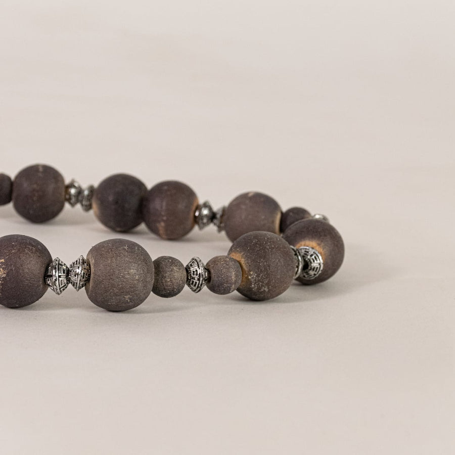 Closeup of decorative wooden bead garland showing round natural beads rustic finish and handcrafted home decor detailing.